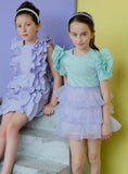 Eloise Dress by MOQUE - light green and pastel purple dress with ruffles on sleeves and skirt